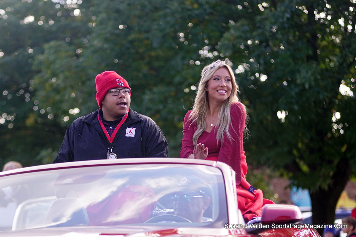 Desmond Reynolds and Lauren Wineman, members of the Royalty Court, greet the crowd who gathered in The Village to watch the homecoming parade